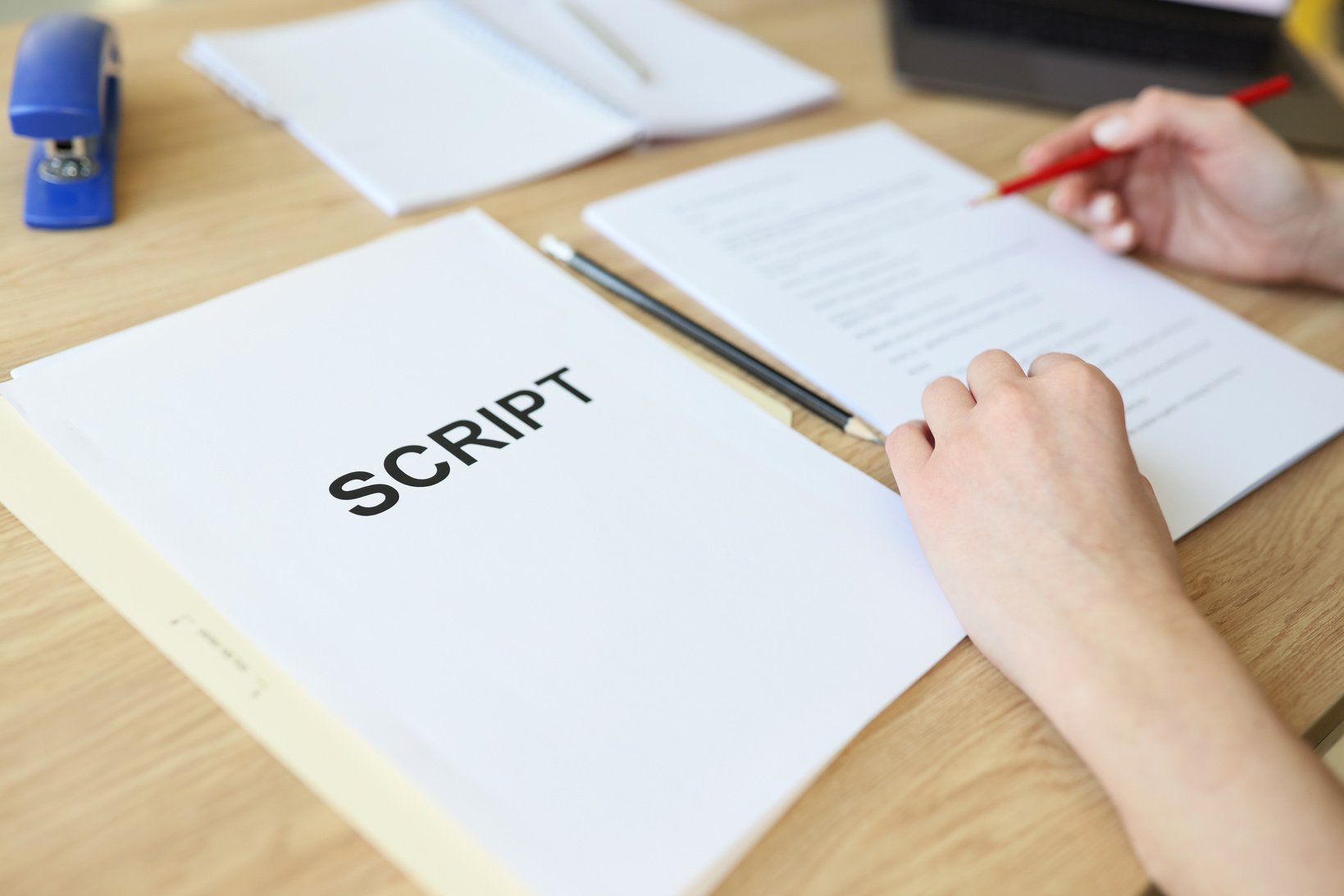 Attentive Woman Reads Script Papers Editing Text with Pencil